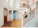 Spacious foyer with wood floors, staircase with black iron railings, and plenty of natural light at 469 Tripp Dr, Golden, CO 80401