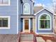 Charming front entrance with arched window, brick accents, and a welcoming 'Hello' mat at 469 Tripp Dr, Golden, CO 80401