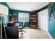 Cozy home office with built-in shelving, a large desk, and a window with natural light at 469 Tripp Dr, Golden, CO 80401