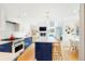 Modern kitchen features a center island, stainless steel appliances, hardwood floors and white and blue cabinetry at 469 Tripp Dr, Golden, CO 80401