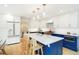 Modern kitchen with a center island, pendant lighting, stainless steel appliances, and white and blue cabinets at 469 Tripp Dr, Golden, CO 80401