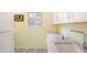 Bright laundry room featuring white cabinets, granite countertops, tile backsplash, and stylish flooring at 469 Tripp Dr, Golden, CO 80401