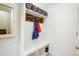 Functional mudroom with custom built-in storage, coat hooks, and tiled flooring at 469 Tripp Dr, Golden, CO 80401