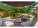 Landscaped patio with comfortable seating nestled among trees, greenery, and stone accents, perfect for outdoor relaxation at 469 Tripp Dr, Golden, CO 80401