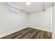 Neutral basement area with wood-look flooring and white baseboards at 8641 Lowell Blvd, Westminster, CO 80031