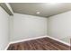 Unfinished basement area with painted walls, neutral ceiling and wood-look flooring at 8641 Lowell Blvd, Westminster, CO 80031