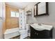Full bathroom featuring a vanity, ceramic tile shower, and a large dark wood framed mirror at 8641 Lowell Blvd, Westminster, CO 80031