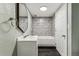 Updated bathroom with patterned tile surround and modern fixtures at 8641 Lowell Blvd, Westminster, CO 80031