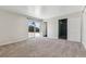 Carpeted bedroom with sliding glass doors to the patio and a large closet at 8641 Lowell Blvd, Westminster, CO 80031