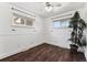 Spare bedroom featuring hardwood floors, baseboards, and two large windows allowing for plenty of natural light at 8641 Lowell Blvd, Westminster, CO 80031