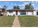 Charming single-story home featuring a well-manicured lawn, front porch and attached garage at 8641 Lowell Blvd, Westminster, CO 80031