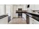 Updated kitchen with stainless steel appliances, tile flooring and modern white cabinets at 8641 Lowell Blvd, Westminster, CO 80031