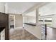 Open concept kitchen with stainless steel appliances, tile floors, and a bar overlooking the living area at 8641 Lowell Blvd, Westminster, CO 80031