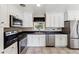Modern kitchen featuring white cabinets, stainless steel appliances and a window at 8641 Lowell Blvd, Westminster, CO 80031