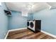 Laundry area with front loading machines and wood-look floors at 8641 Lowell Blvd, Westminster, CO 80031