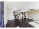View of the open-concept living room with dark hardwood floors and access to the kitchen at 8641 Lowell Blvd, Westminster, CO 80031