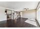Open-concept living room with dark hardwood floors and access to the kitchen area at 8641 Lowell Blvd, Westminster, CO 80031