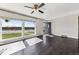 Bright living room featuring hardwood floors, a ceiling fan, and a large window at 8641 Lowell Blvd, Westminster, CO 80031