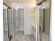 Bathroom with dual vanities, mirrored closet doors, and tile flooring at 14152 E Linvale Pl # 311, Aurora, CO 80014