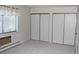 Bedroom with neutral carpet, a window with blinds, and closets for ample storage at 14152 E Linvale Pl # 311, Aurora, CO 80014