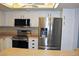 Well-lit kitchen with white cabinetry, stainless steel appliances, and modern fixtures at 14152 E Linvale Pl # 311, Aurora, CO 80014
