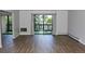 Bright living room featuring wood-look floors and sliding glass doors to a balcony at 14152 E Linvale Pl # 311, Aurora, CO 80014