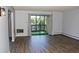 Bright living room features wood-look floors and balcony with sliding glass doors at 14152 E Linvale Pl # 311, Aurora, CO 80014