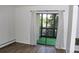 Bright living room features wood-look floors and balcony with sliding glass doors at 14152 E Linvale Pl # 311, Aurora, CO 80014