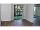 Bright living room featuring wood-look floors and sliding glass doors to a balcony at 14152 E Linvale Pl # 311, Aurora, CO 80014
