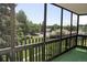 View from the enclosed patio shows lush greenery and neighborhood homes at 14152 E Linvale Pl # 311, Aurora, CO 80014