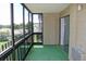 Enclosed sunroom with green carpeting, floor-to-ceiling windows, and exterior views at 14152 E Linvale Pl # 311, Aurora, CO 80014