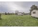 Expansive backyard with a well, outbuildings, hot tub, and open green space at 1062 Pinon Ln, Elizabeth, CO 80107
