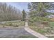 Serene backyard garden featuring a stone pathway, red hammock, and mature trees at 1062 Pinon Ln, Elizabeth, CO 80107