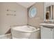 Bathroom featuring a corner tub with tile surround and a vanity with countertop at 1062 Pinon Ln, Elizabeth, CO 80107