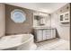Bathroom with a corner soaking tub, double sink vanity, and decorative wall accents at 1062 Pinon Ln, Elizabeth, CO 80107