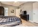 Inviting bedroom features a dark wood dresser, light wood floors, and tasteful wall decor at 1062 Pinon Ln, Elizabeth, CO 80107