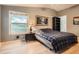 Cozy bedroom with a plaid comforter, natural light from the window, and a serene atmosphere at 1062 Pinon Ln, Elizabeth, CO 80107