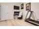 Bedroom featuring a treadmill, desk, office chair, a TV and plank flooring at 1062 Pinon Ln, Elizabeth, CO 80107