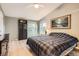 Comfortable bedroom with a plaid comforter on the bed, a ceiling fan, and a light wood floor at 1062 Pinon Ln, Elizabeth, CO 80107
