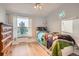 bedroom with a Paw Patrol themed bed, wood floors, and a bright window view at 1062 Pinon Ln, Elizabeth, CO 80107