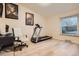 Spacious room featuring a treadmill, desk with chair, and a large window providing plenty of natural light at 1062 Pinon Ln, Elizabeth, CO 80107
