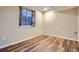 Bedroom featuring dark-stained hardwood-style floors and natural light from window at 1062 Pinon Ln, Elizabeth, CO 80107