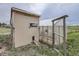 Exterior of a shed and greenhouse combo surrounded by lush greenery and open fields at 1062 Pinon Ln, Elizabeth, CO 80107
