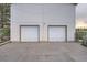 Two-car garage with white doors, a large driveway, and a well-maintained exterior at 1062 Pinon Ln, Elizabeth, CO 80107