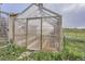 View of greenhouse adjacent to fenced pasture at 1062 Pinon Ln, Elizabeth, CO 80107