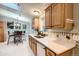 Eat-in kitchen area featuring wood cabinets, stainless steel appliances, and an adjacent dining nook at 1062 Pinon Ln, Elizabeth, CO 80107