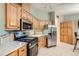 Well-equipped kitchen features stainless steel appliances, ample cabinetry, and tiled floors at 1062 Pinon Ln, Elizabeth, CO 80107