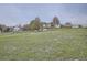 Expansive grassy land surrounding a home, showcasing the property's spacious outdoor area and potential at 1062 Pinon Ln, Elizabeth, CO 80107