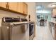 Laundry room featuring a modern washer and dryer set, wood cabinets, tile floors and neutral paint at 1062 Pinon Ln, Elizabeth, CO 80107