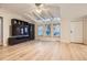 Spacious living room with wood floors, vaulted ceiling, and exterior views through multiple windows at 1062 Pinon Ln, Elizabeth, CO 80107